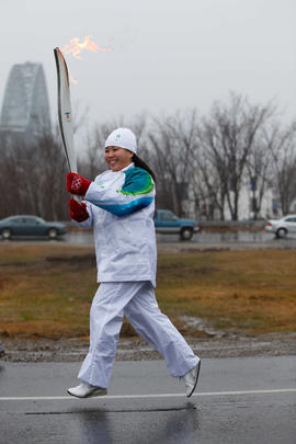 Day 29 Torchbearer 67 Sara Chow carrying the flame in Miramichi, New Brunswick.