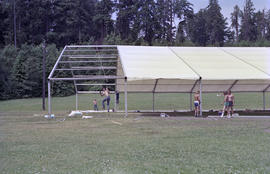 Group of men installing event tent
