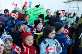 Day 9 elementary school crowd gathers at Thompson, MB Airport to welcome the flame.