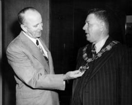 C. E. Thompson and unidentified individual wearing Mayor's chain