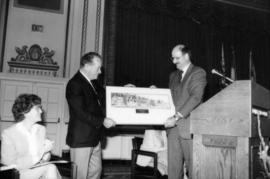 Mike Harcourt presents framed print to unidentified man