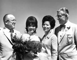 P.N.E. directors M.L. Barr and T.A. Steeves with performers from the Dorothy Toy Oriental Doll Revue