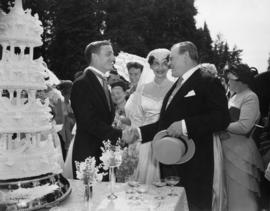 E.W. Hamber congratulating the bride and groom at their wedding reception