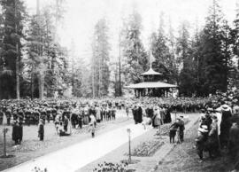 [Large gathering in Stanley Park near bandstand]