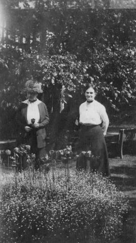 Adaline Hendry with a friend standing in a garden