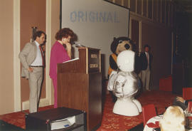 Linda Graham at podium looking towards Expo Ernie and Tillicum