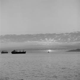 Two ships anchored in English Bay at sunset