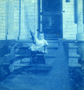 Katharine with her doll upside down