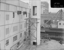 Powerhouse construction - view of base of chimney and exterior wall of powerhouse