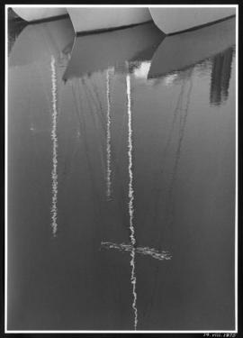 Reflection of 3 masts in the water