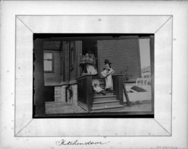 [Women and child at] Kitchen door