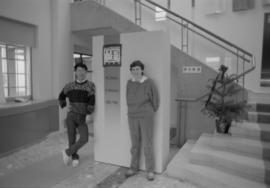 Paul Yee and Elizabeth Shefrin standing by a sign at the Saltwater City exhibit