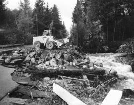 [Clearing the debris of the washed-out road at 25th Street and Mathers Avenue]