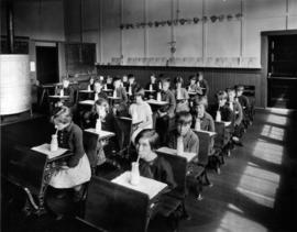 Children drinking milk in classroom at Open Air School