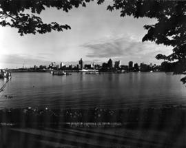 View from Stanley Park of Vancouver skyline with oil barge in foreground in Coal Harbour