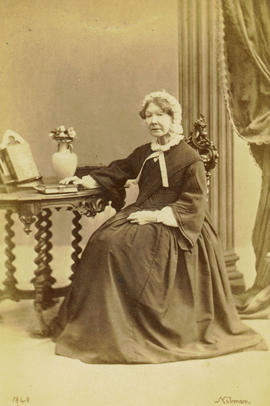 [Studio portrait of older woman in cap, seated]