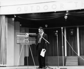Man on stage with an abacus