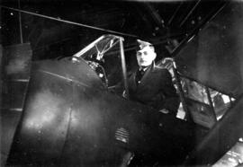 [R.C.A.F. Squadron Leader Jack Gledhill sitting in cockpit]