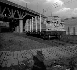 [Rail car loaded with lumber at the Canada Customs Sufferance Warehouse by the Georgia Viaduct]