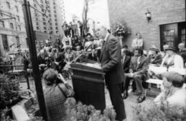 Unidentified man speaking from podium