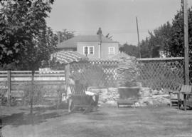 [View of a backyard seating area with fireplace]