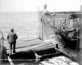 Fishermen and their nets beside dock on the Fraser River