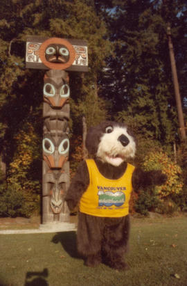 Tillicum in front of totem poles at Brockton Point