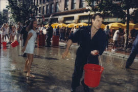 "Giant Fire Drill" participant running with bucket of water