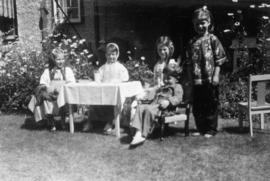 Children playing dress up outside