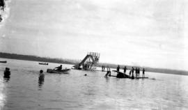 People swimming in English Bay, gathered on slide and diving board