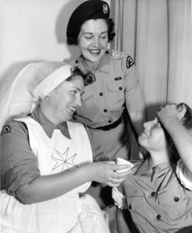 St. John Ambulance Brigade members with young girl