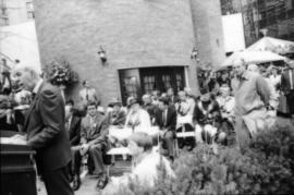 Unidentified man speaking from podium