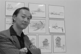 Artist Raymond Chow at a display of his drawings