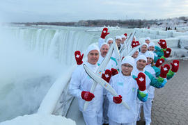 Day 52 Torchbearer Team posing beside the falls before his run in Niagara Falls, Ontario