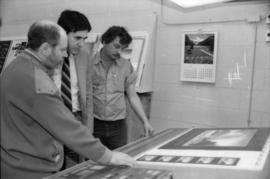 Toni Onley, Robert Dubberley and unidentified man examine Centennial Art Series print at Agency P...