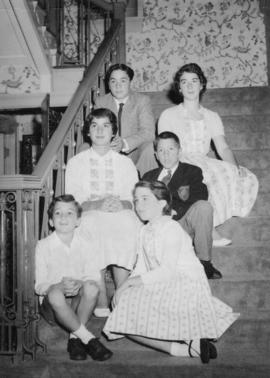 Group of children sitting on carpeted stairs