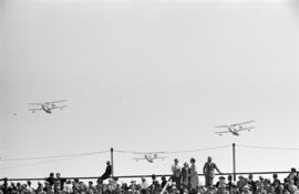 [Three biplanes in flight]