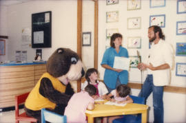 Tillicum colouring with children seated at table