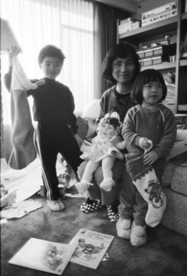 Woman, boy, and girl with doll