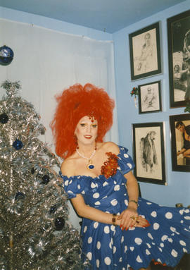 Adrian Alexandria de Vander Vogue posing beside a Christmas tree