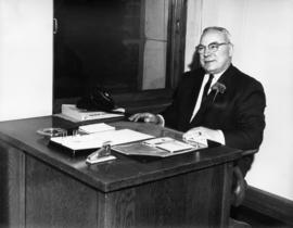 Bertram Emery sitting at a desk