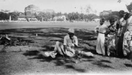 [A man performing with people watching him]