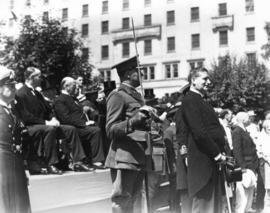 [Ian MacKenzie, M.P. viewing a Dominion Day parade]