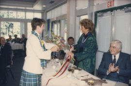 Centennial staff member handing bouquet to Alison Reid