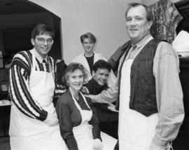 Portrait of group wearing aprons