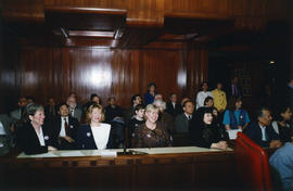 Group at speaker podium in council chambers at International Day to End Racial Discrimination cer...