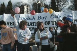 Centennial commissioners in front of English Bay Café banner at Polar Bear Swim