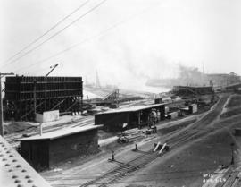 [Progress photograph of a construction and rail yard next to Pier "B/C"]