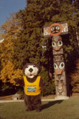 Tillicum in front of totem poles at Brockton Point