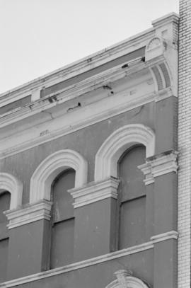 [Detail view of upper windows and cornices at 36 West Cordova Street, 2 of 2]